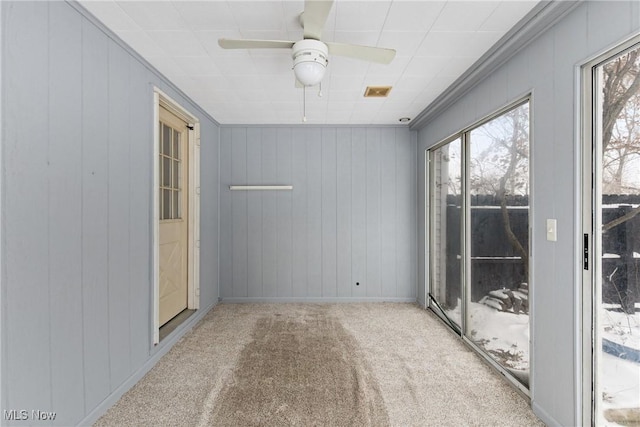 carpeted spare room with ceiling fan