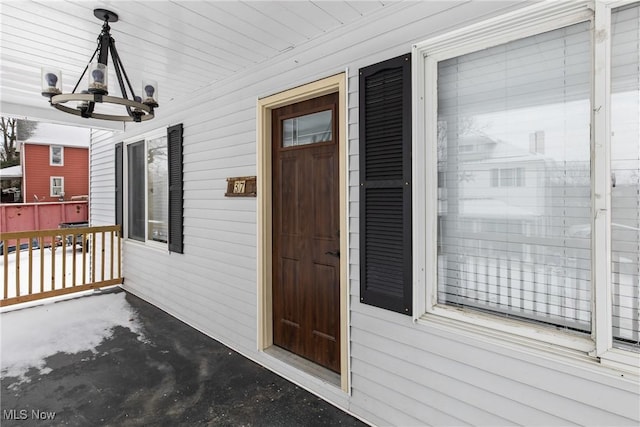 view of exterior entry with a porch