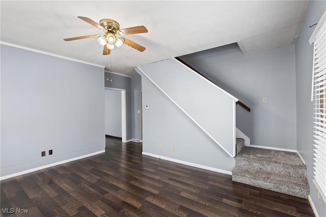 unfurnished living room with dark hardwood / wood-style flooring, ceiling fan, and crown molding