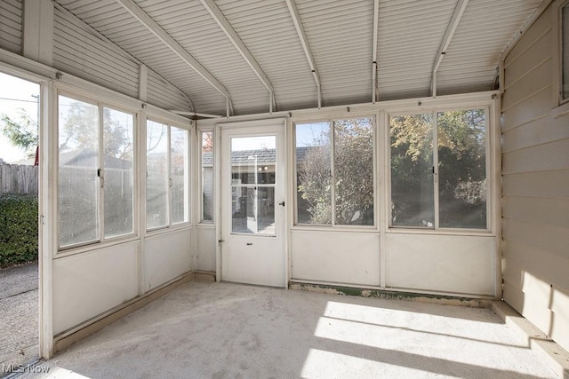 unfurnished sunroom featuring lofted ceiling