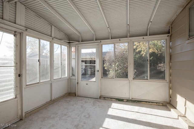 unfurnished sunroom featuring a wealth of natural light and vaulted ceiling