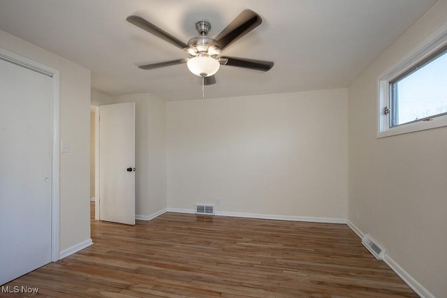 unfurnished room with ceiling fan and dark wood-type flooring