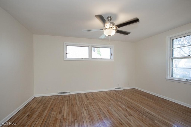 unfurnished room with ceiling fan and wood-type flooring