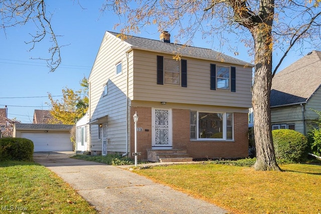 view of front facade featuring a garage, a front lawn, and an outdoor structure