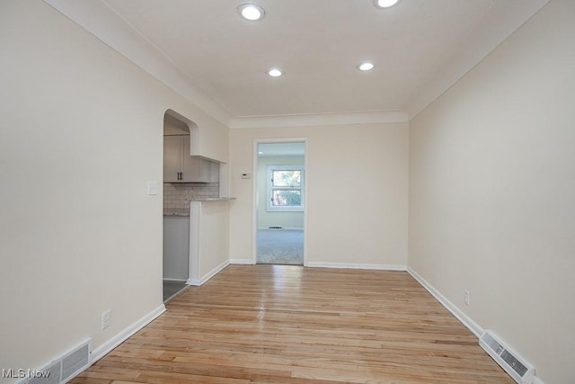 interior space featuring crown molding and light wood-type flooring