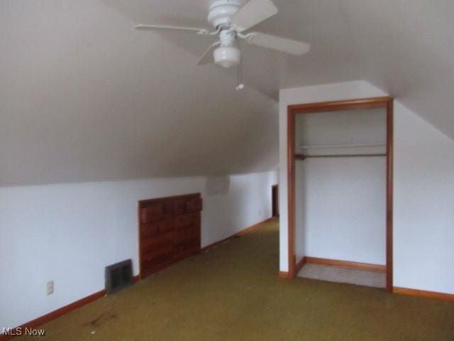 additional living space with carpet flooring, ceiling fan, and vaulted ceiling