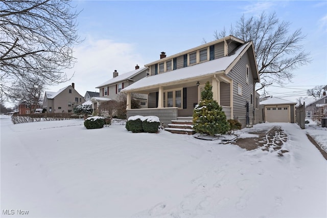 view of front of house featuring an outbuilding, a porch, and a garage