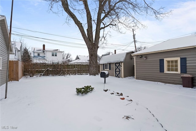 snowy yard with a storage unit