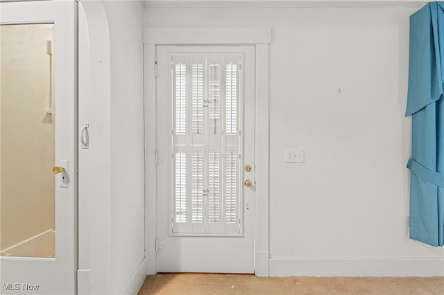 foyer entrance featuring light colored carpet