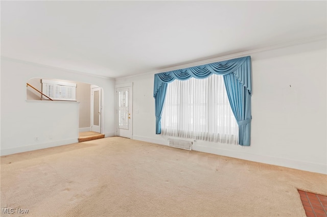 carpeted empty room featuring ornamental molding