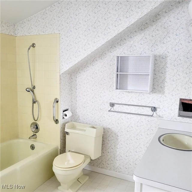 full bathroom featuring vanity, toilet, tiled shower / bath, and vaulted ceiling