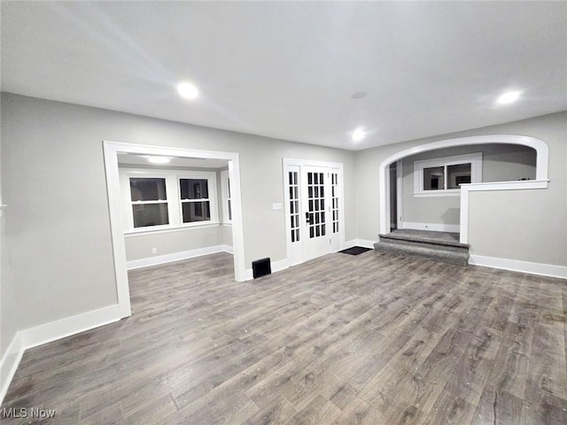 unfurnished living room featuring french doors and hardwood / wood-style floors