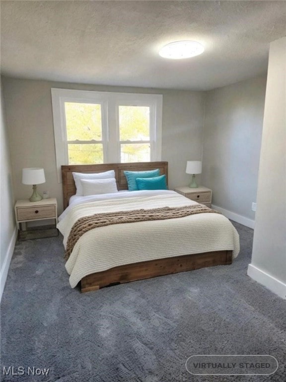 carpeted bedroom with a textured ceiling