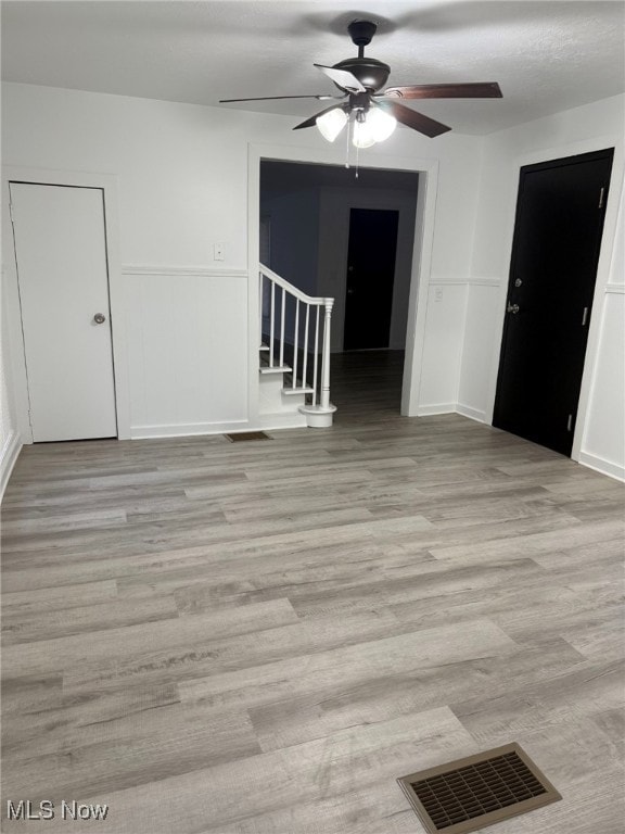 unfurnished room featuring ceiling fan and light hardwood / wood-style flooring