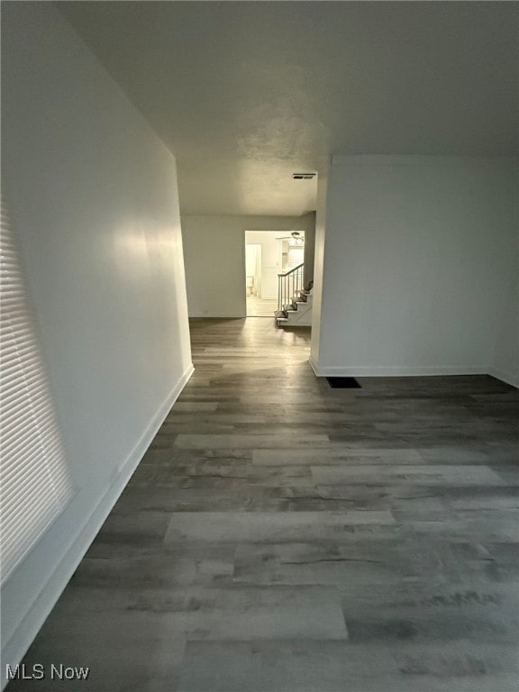 corridor featuring dark wood-type flooring