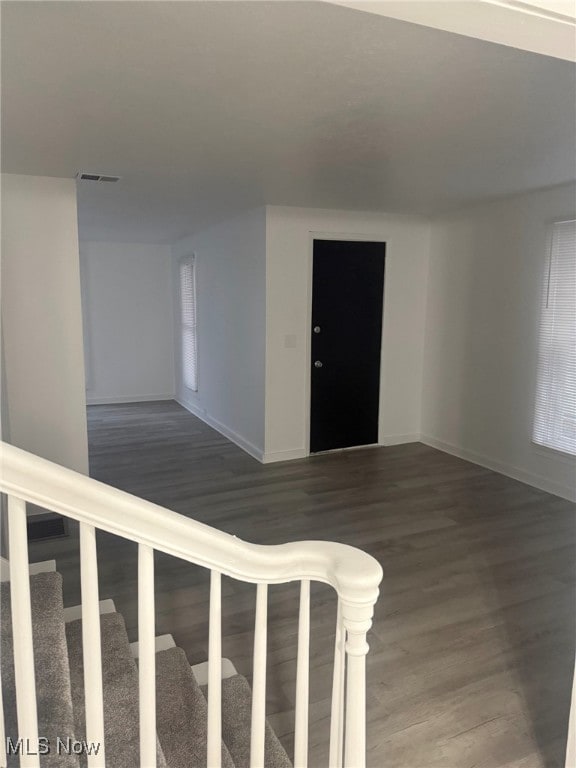 unfurnished room featuring dark hardwood / wood-style flooring