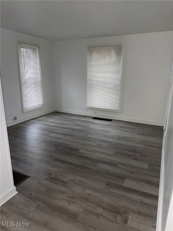 unfurnished room with dark hardwood / wood-style floors