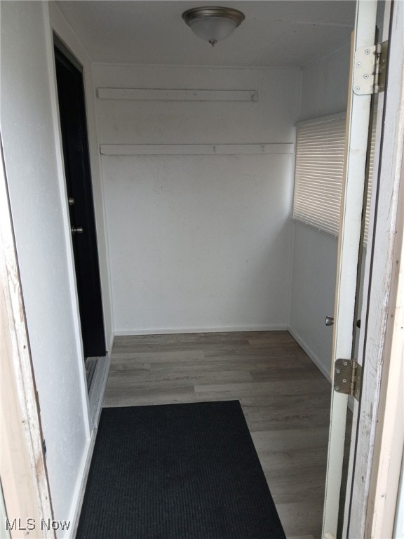 corridor with dark hardwood / wood-style flooring