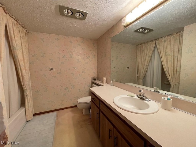 full bathroom with vanity, toilet, a textured ceiling, and shower / tub combo