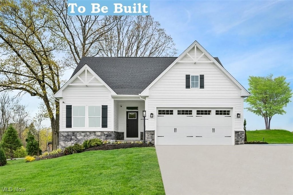 view of front of house featuring a garage and a front yard