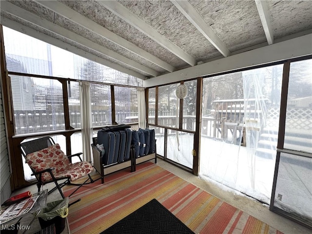 sunroom with vaulted ceiling with beams