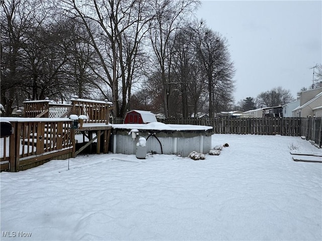 snowy yard featuring a deck