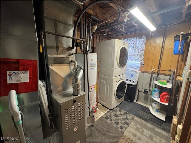 laundry room with stacked washer / drying machine and gas water heater