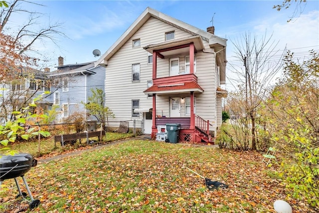 rear view of house with a yard