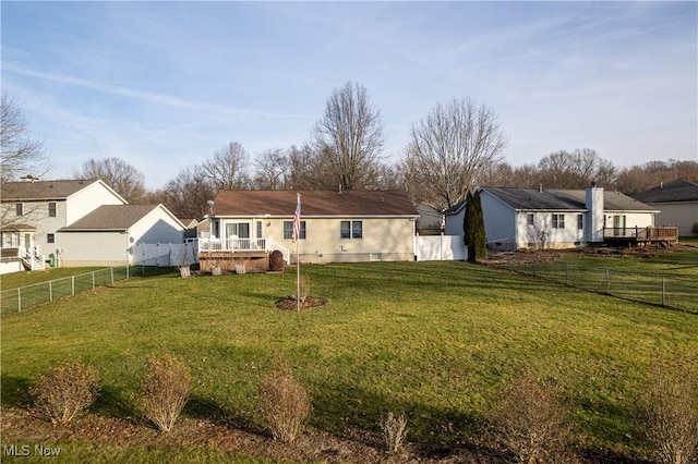 rear view of property featuring a yard