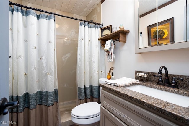 bathroom featuring vanity, toilet, and curtained shower