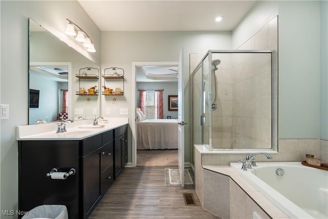 bathroom featuring vanity, hardwood / wood-style flooring, and separate shower and tub