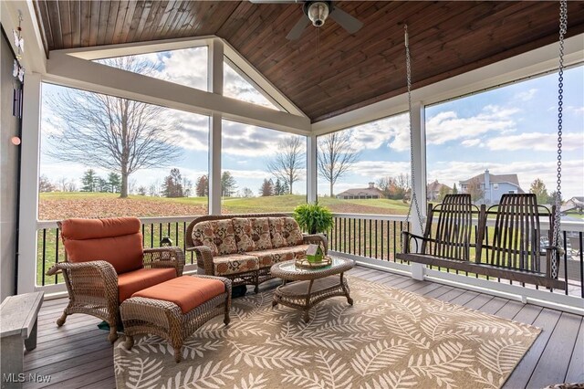 sunroom / solarium with ceiling fan, lofted ceiling, and wood ceiling