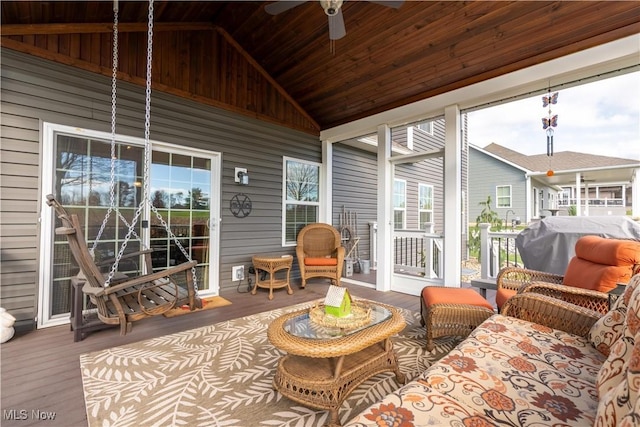 sunroom / solarium with ceiling fan, wood ceiling, and vaulted ceiling