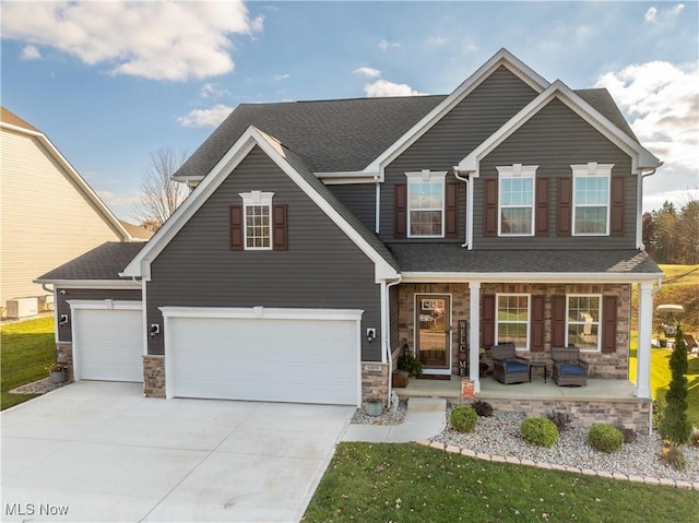 view of front of house featuring covered porch and a garage