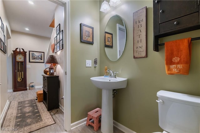 bathroom featuring sink, wood-type flooring, and toilet