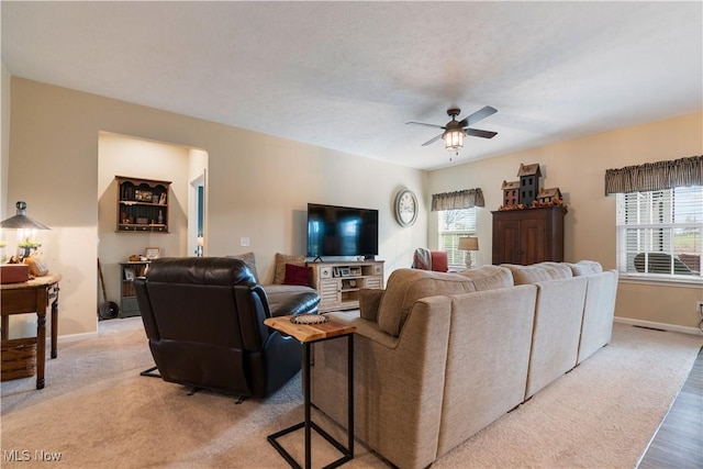 living room featuring ceiling fan and light hardwood / wood-style floors