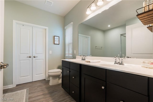 bathroom featuring hardwood / wood-style flooring, vanity, and toilet