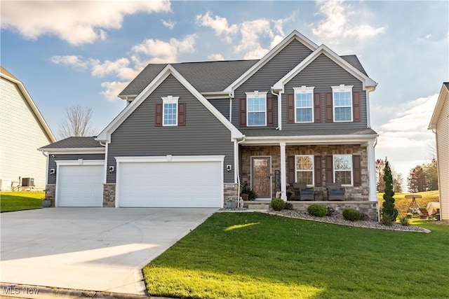 craftsman inspired home with covered porch, a garage, and a front lawn