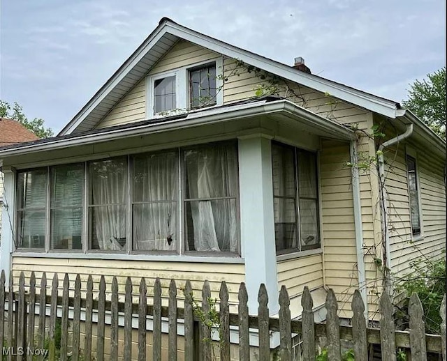 view of side of property with a sunroom