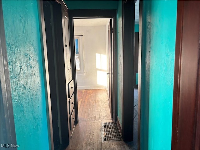 hallway with hardwood / wood-style floors