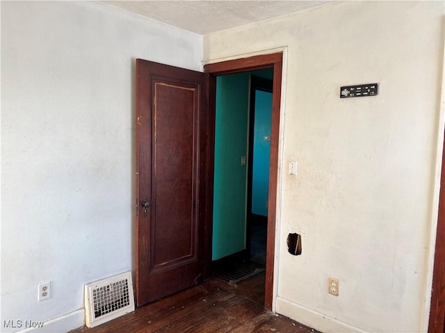 unfurnished room featuring dark hardwood / wood-style flooring