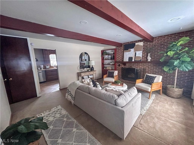 living room with beam ceiling, brick wall, and a brick fireplace