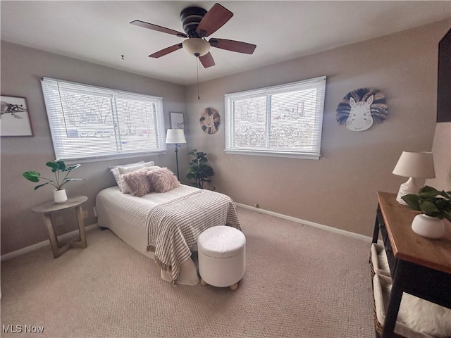 bedroom featuring carpet flooring, multiple windows, and ceiling fan