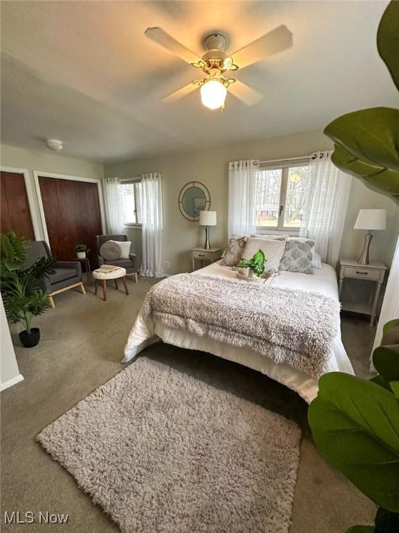 bedroom with multiple windows, carpet, and ceiling fan