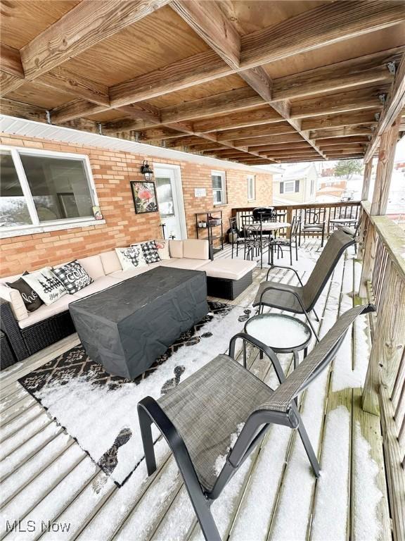 wooden terrace with an outdoor hangout area