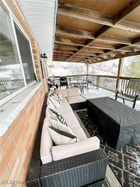 view of snow covered back of property