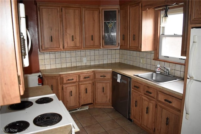 kitchen featuring white refrigerator, sink, stainless steel dishwasher, tasteful backsplash, and light tile patterned flooring