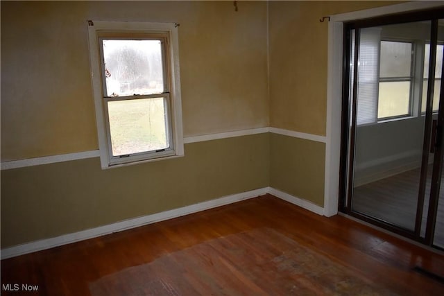 unfurnished room featuring dark hardwood / wood-style flooring