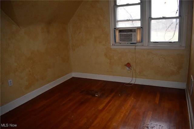 bonus room with dark hardwood / wood-style floors and cooling unit