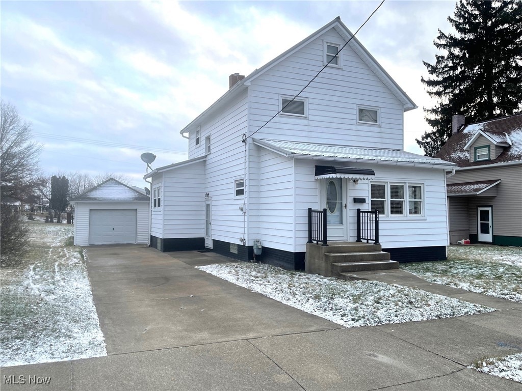 view of front of home featuring a garage and an outdoor structure